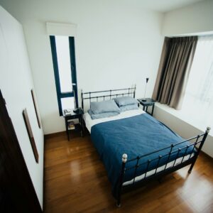blue and white bed sheet and black bed frame in room