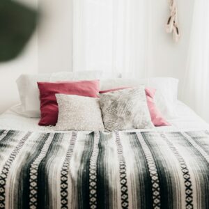 bed with throw pillows and blanket